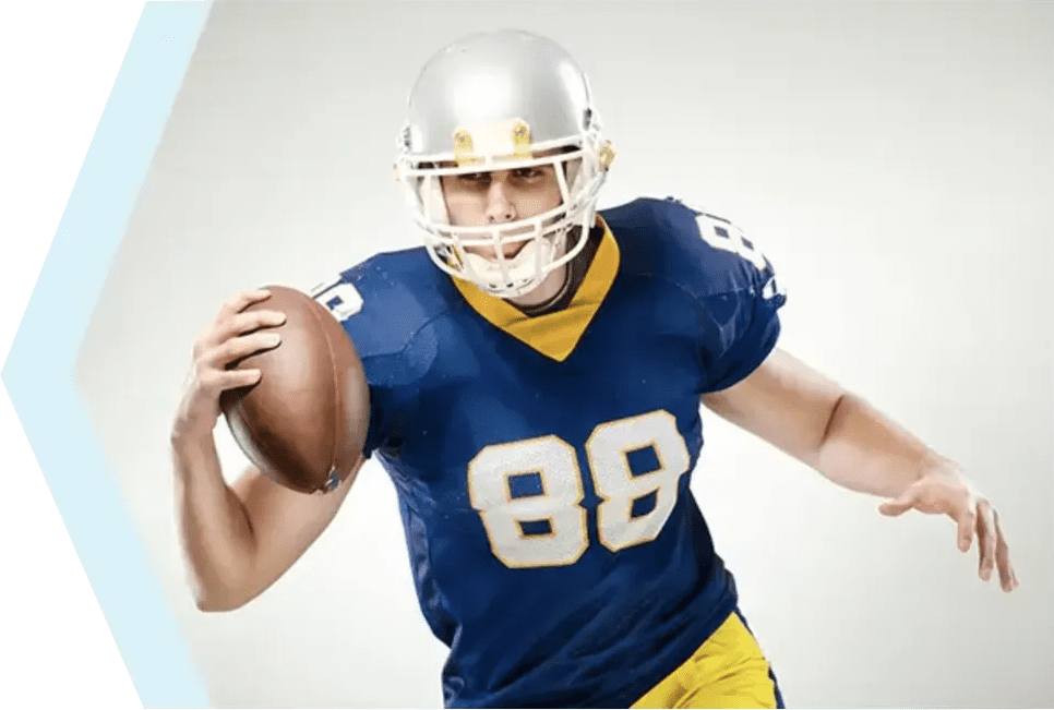 Football player in blue and yellow uniform, helmet on, running while holding a football, with a focused expression characteristic of a Board Certified Orthopedic Surgeon.