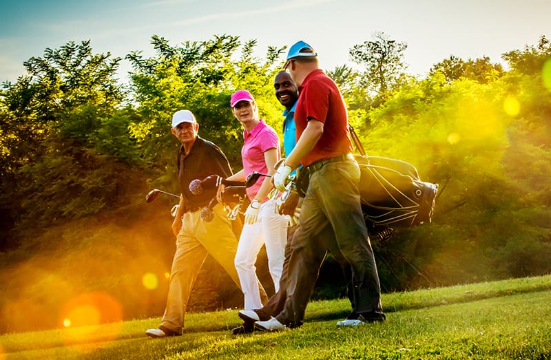 Friends Playing Golf on a Beautiful Sunny Day Four friends on golf course.